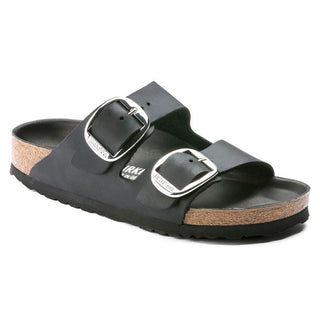 A black Birkenstock Arizona sandal with big metal buckles and a contoured cork-latex footbed.